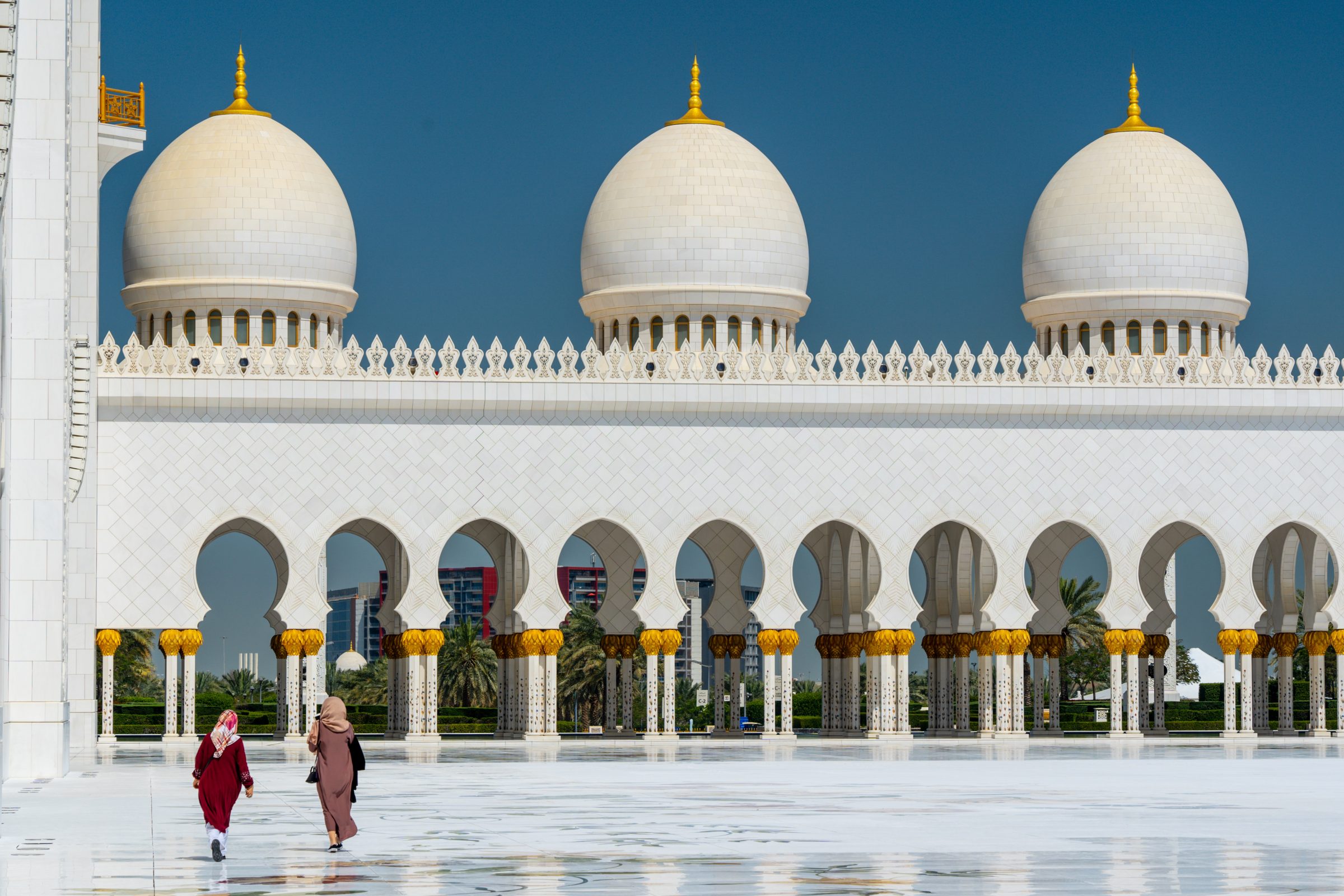 Två kvinnor iklädda i burkha går utanför en moské i Abu Dhabi, i Förenta Arab Emiraterna