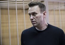 Putinkritikern Navalnyj anklagas för att ha utfört ett terroristbrott medan han suttit fängslad På bilden syns Aleksej Navalnyj i profil med en svart tröja på.